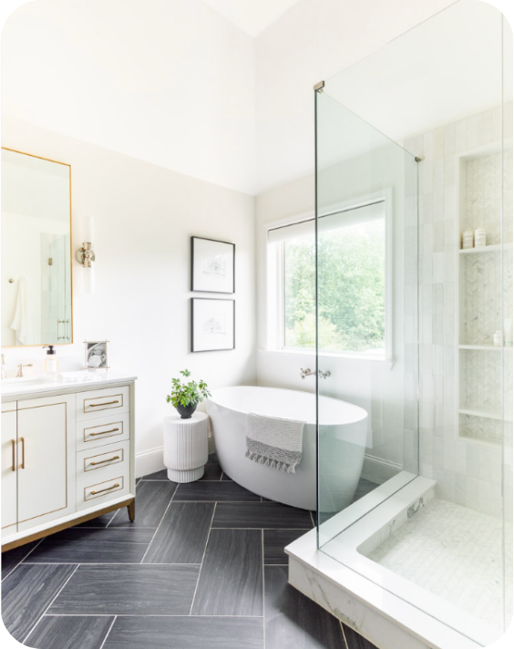 A bright, newly remodeled bathroom with a freestanding soaking tub, a glass walk-in shower, and a modern vanity